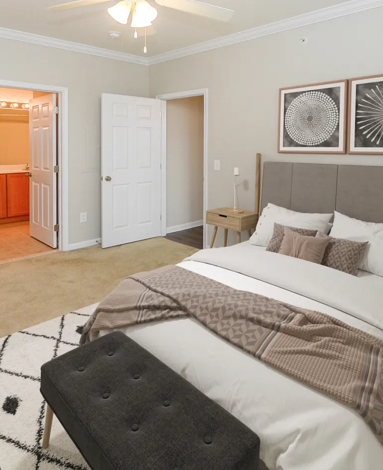 Comfortable bedroom with high ceilings in a Meridian Crossing apartment