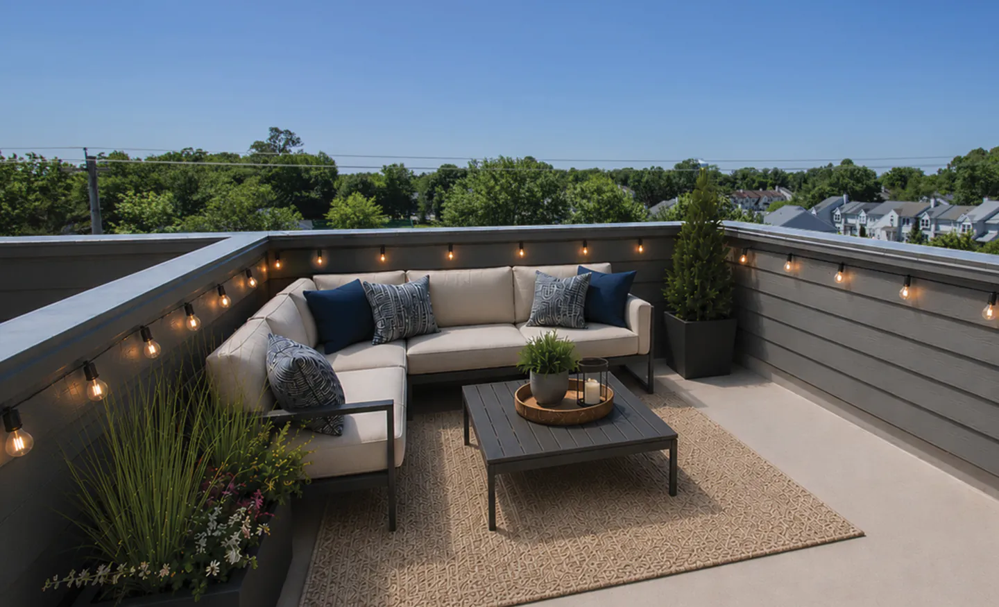 Furnished rooftop deck at Lincoln Center with string lights and treetop views